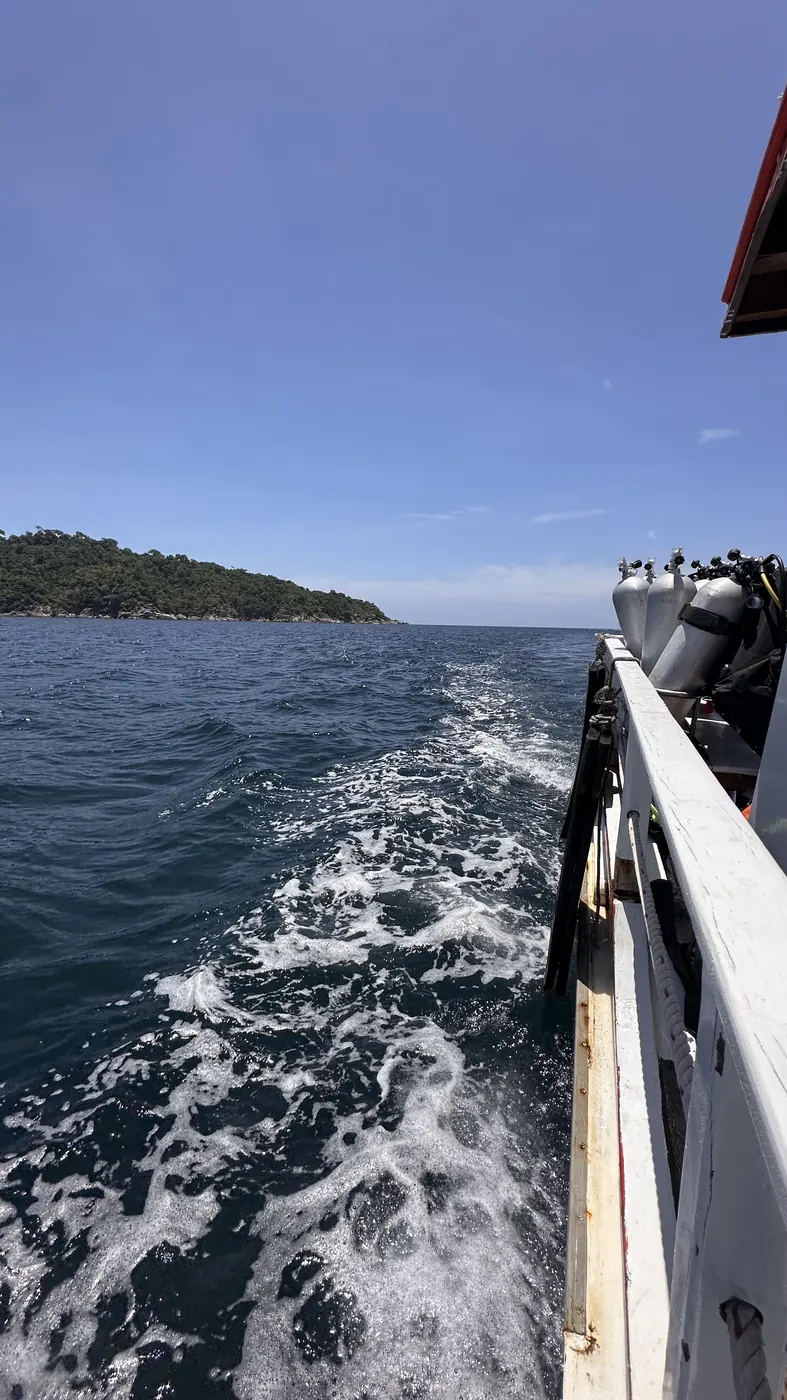 Dive boat heading offshore from Koh Lipe — open Andaman Sea behind