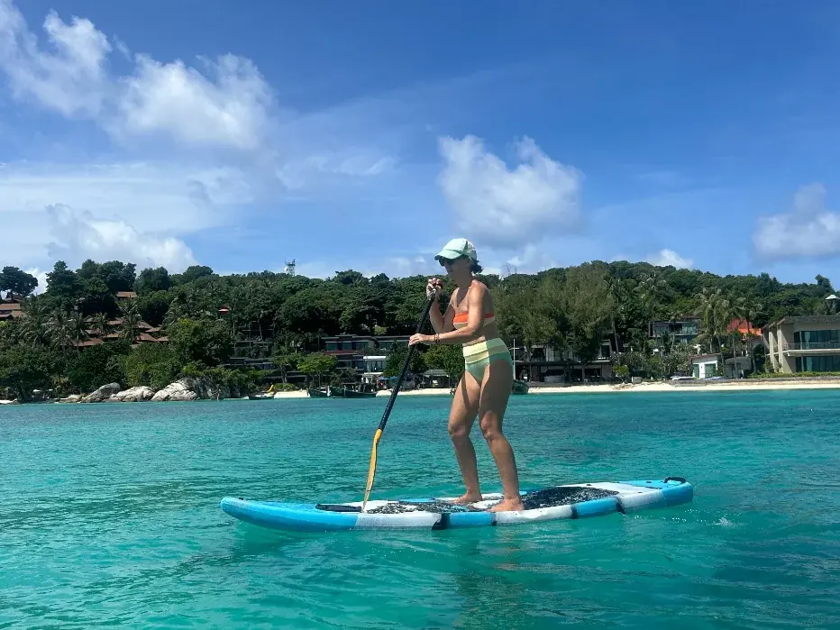 Paddleboarding off Sunrise Beach in glassy morning water