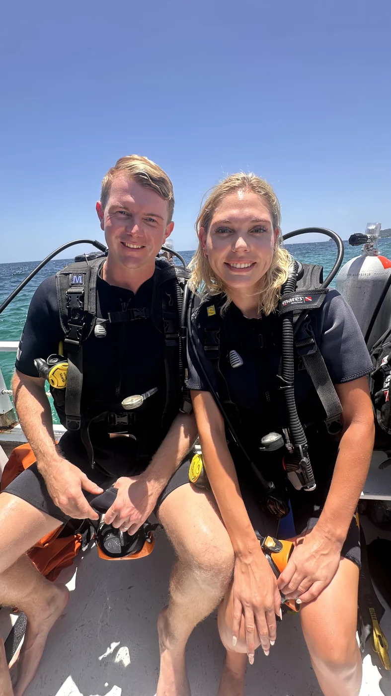 Two first-time scuba students sitting on the dive boat after a successful try dive, Koh Lipe